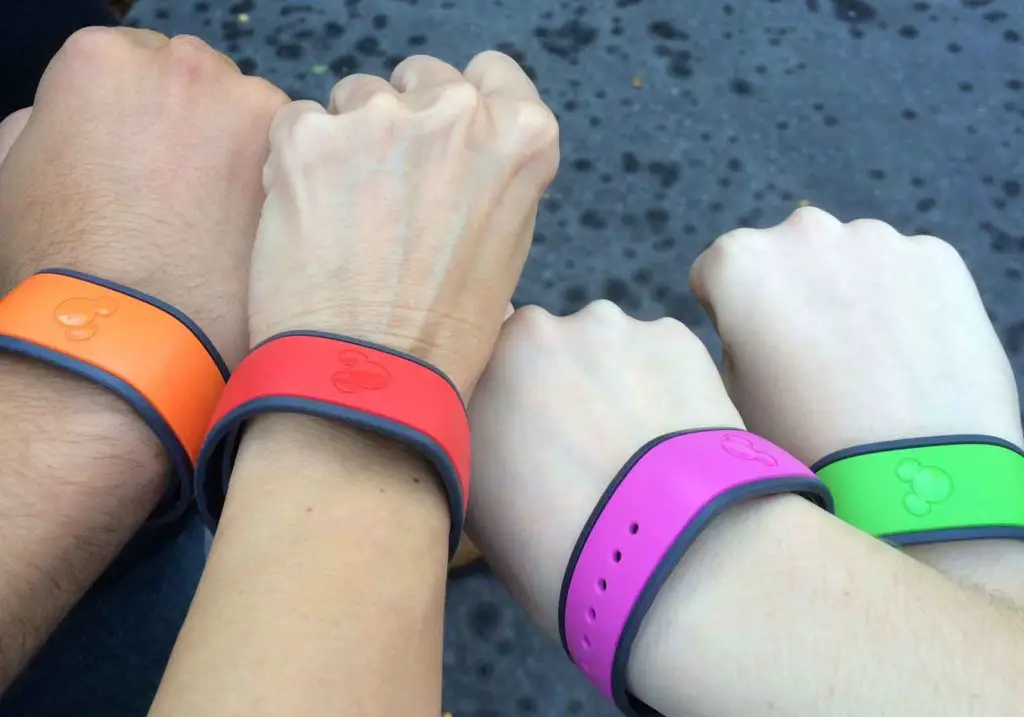 Magic Bands in orange, red, pink and green linked to FastPass+ reservations