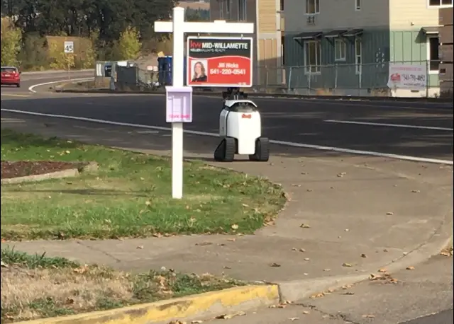 Philomath delivery robot rolling down a sidewalk near Philomath's center.