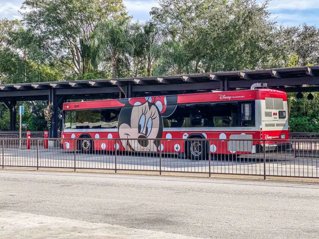 Bus decorated in a Minnie Mouse theme, part of the Disney World transportation system