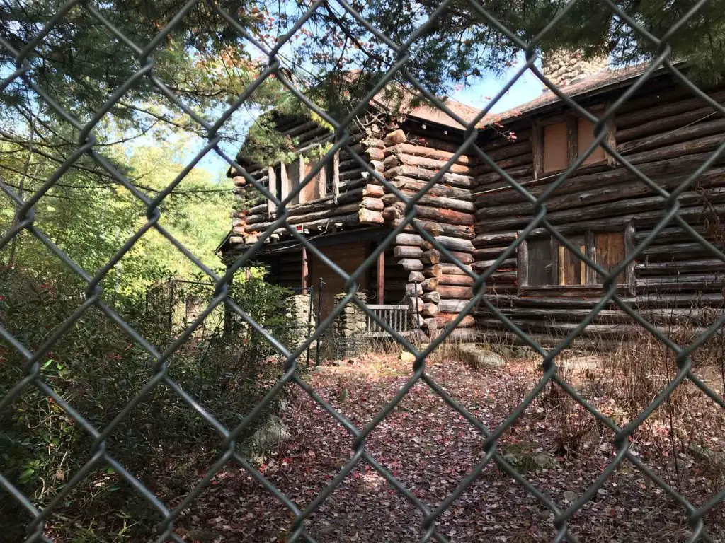 Carol Maude Case Dennison cabin behind a chain link fence