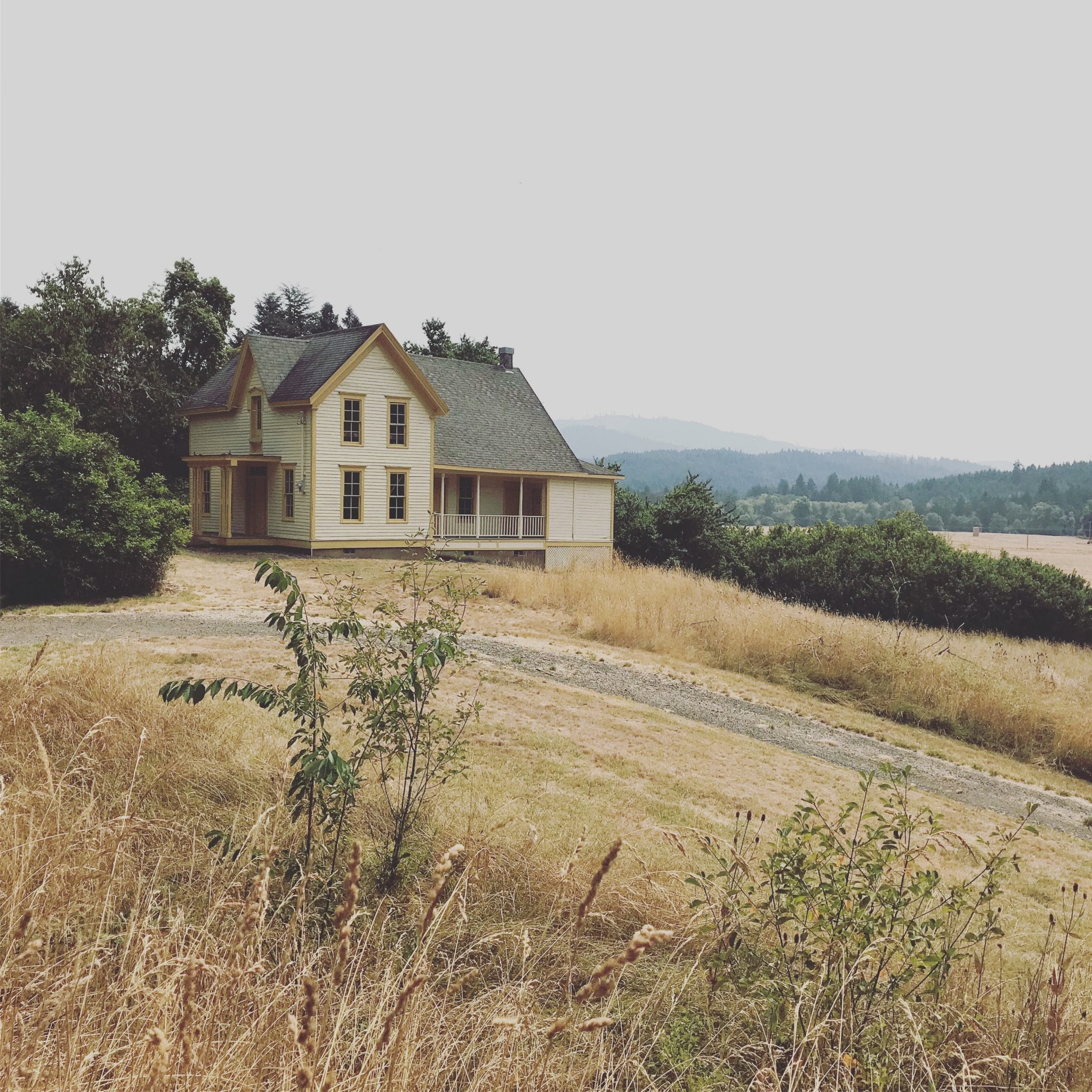 a historic home in a field located at Fort Hoskins