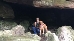 Travel blogger, Ali Patton, poses with mascot Nemo in a cave at Chatfield Hollow State Park in Connecticut