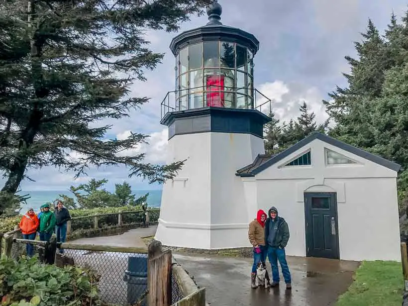 Cape Meares lighthouse with us standing in front of it for perspective on the size