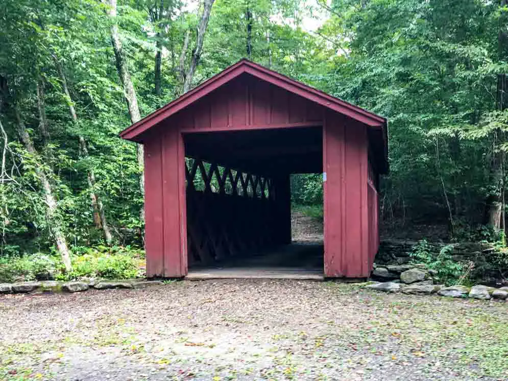 red covered bridge leading off to a hike at Chatfield Hollow State Park
