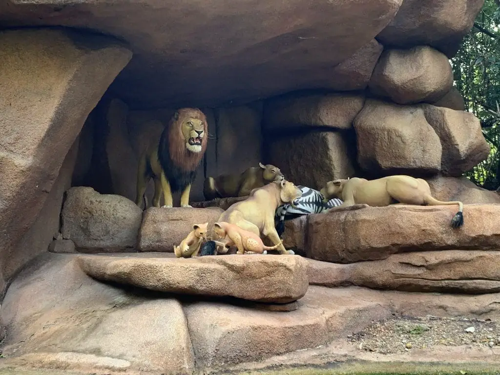 lions resting on a rock in the Jungle Cruise, a Walt Disney World Lightning Lane enabled ride.