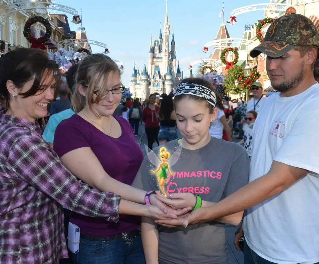 Tinkerbelle on the hands of Disney visitors from the Memory Maker