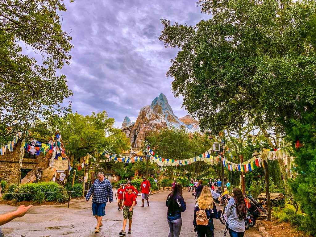 View of Expedition Everest in the distance as guests walk down the pathways of Disney World Animal Kingdom Park