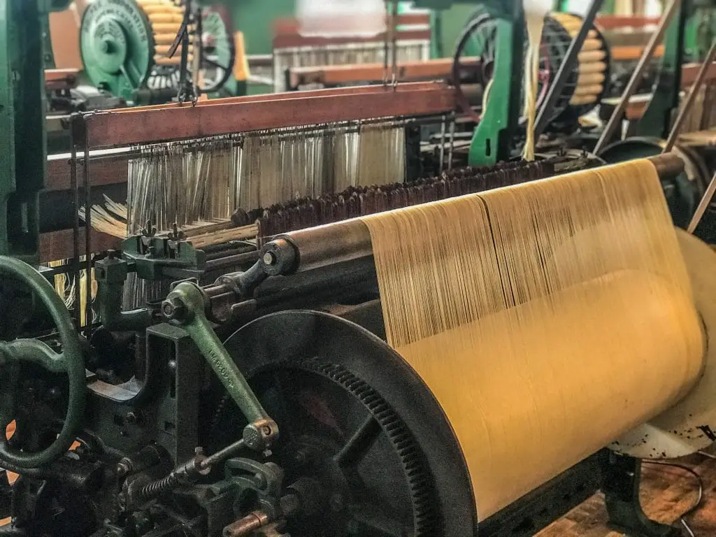 power loom actively weaving cloth in Lowell National historical Park