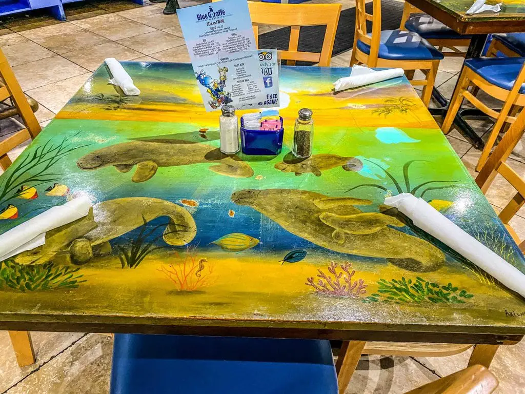 Handpainted table featuring manatees at the Blue Giraffe, a restaurant on Sanibel Island.