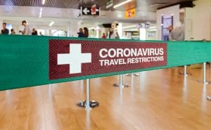 banner warning travelers of coronavirus travel restrictions