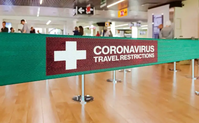 banner warning travelers of coronavirus travel restrictions