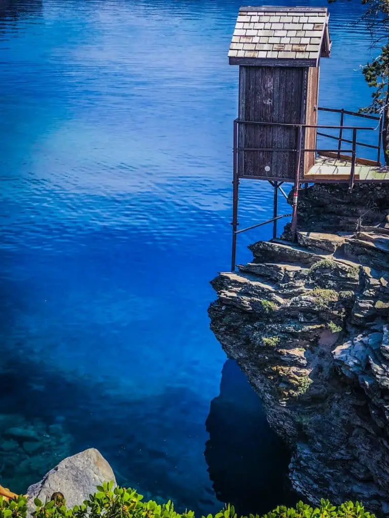 Blue water of Crater Lake with outbuilding suspended over the water