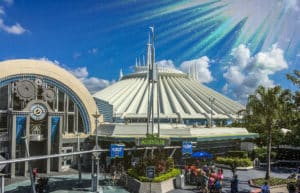 Space Mountain ride building with a sun flare and blue sky