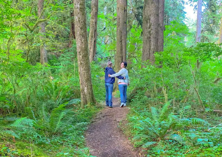 Mother-daughter travel blogger team enjoying an Oregon hiking trail through old growth forest