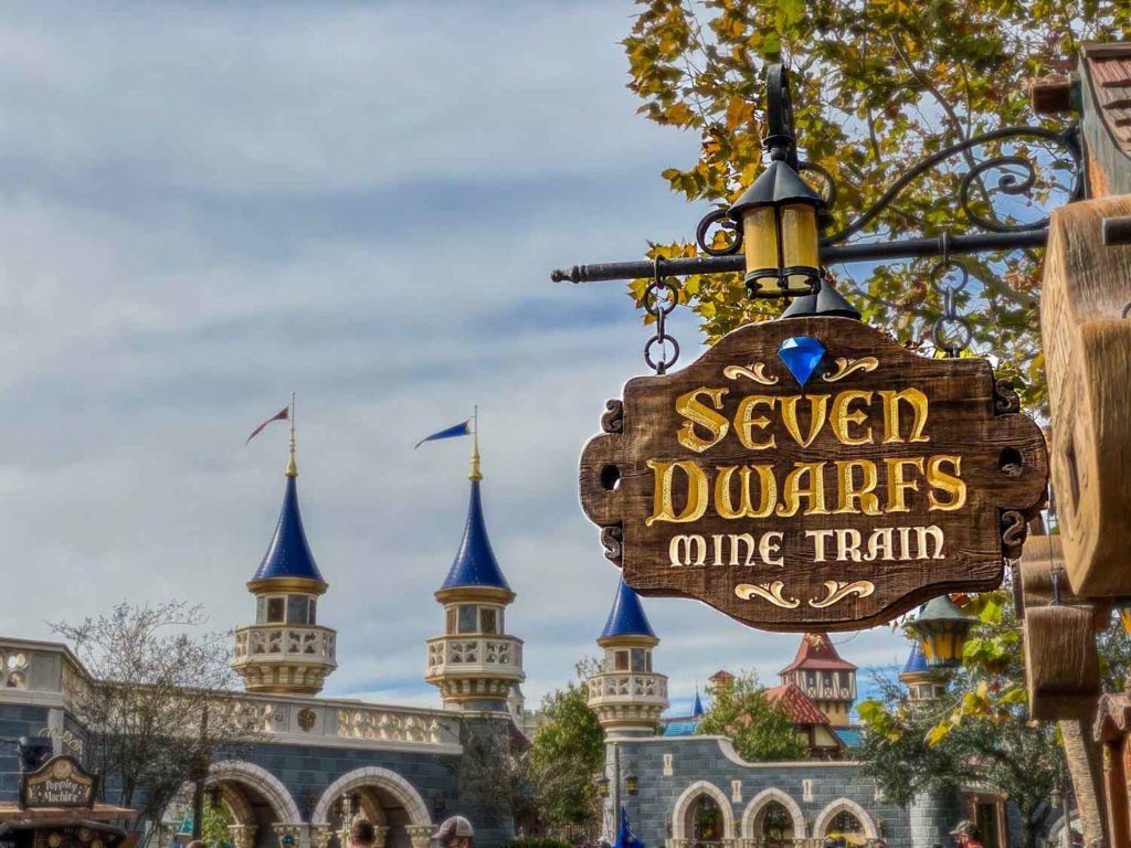 Sign for 7 Dwarfs mine train ride, a unique experience when comparing disney world vs disneyland rides