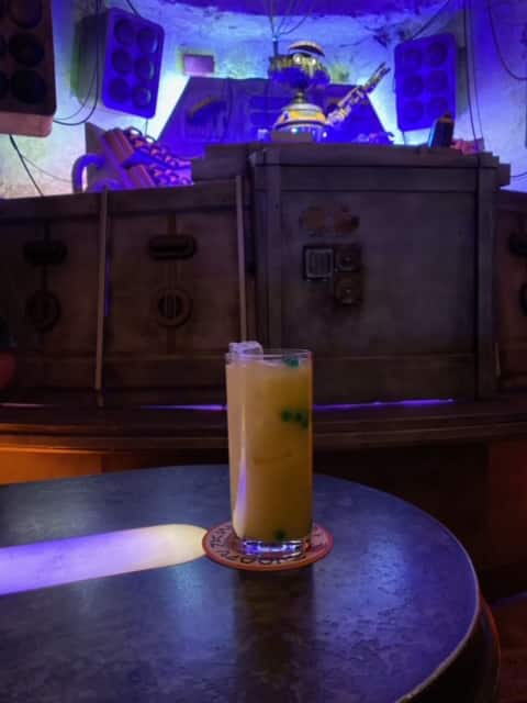 Cocktail inside Oga's Cantina with REX in the background. 