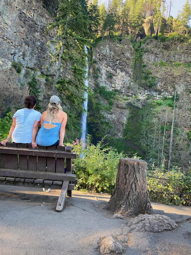Mother daughter travel bloggers enjoy the view of Multnomah Falls from the trail