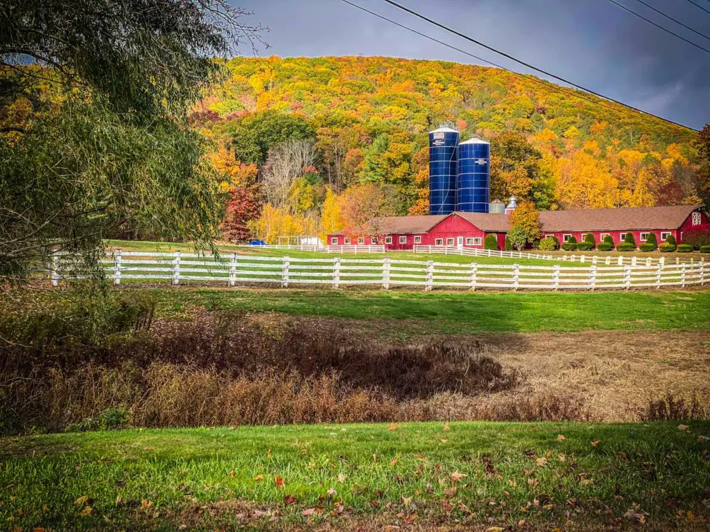 New England farm surrounded by the colors of fall