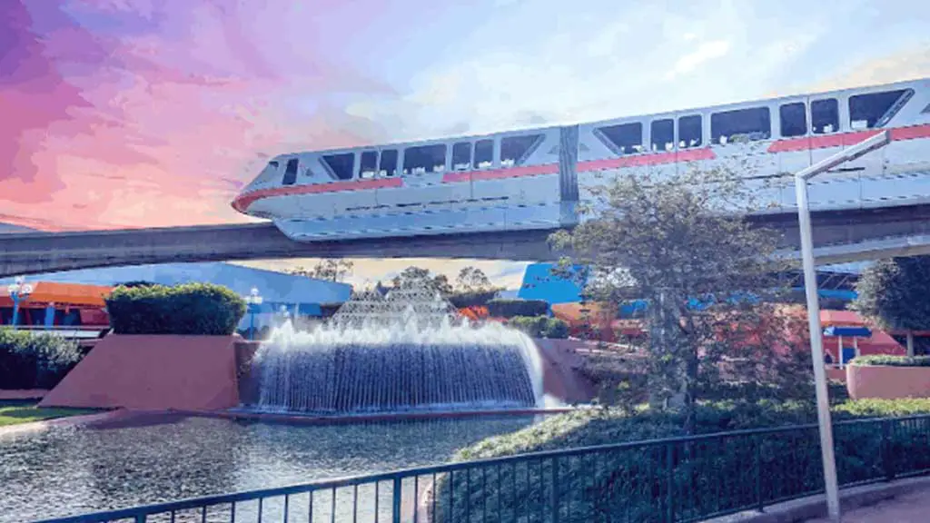 Disney World monorail against pink sky.