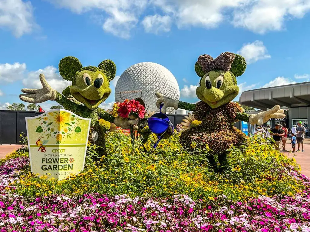 Mickey and Minnie topiaries frame Spaceship Earth in EPCOT, one of the best Disney World parks.