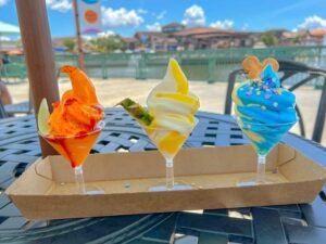 A Dole Whip flight served at Disney Springs pictured in front of the water.