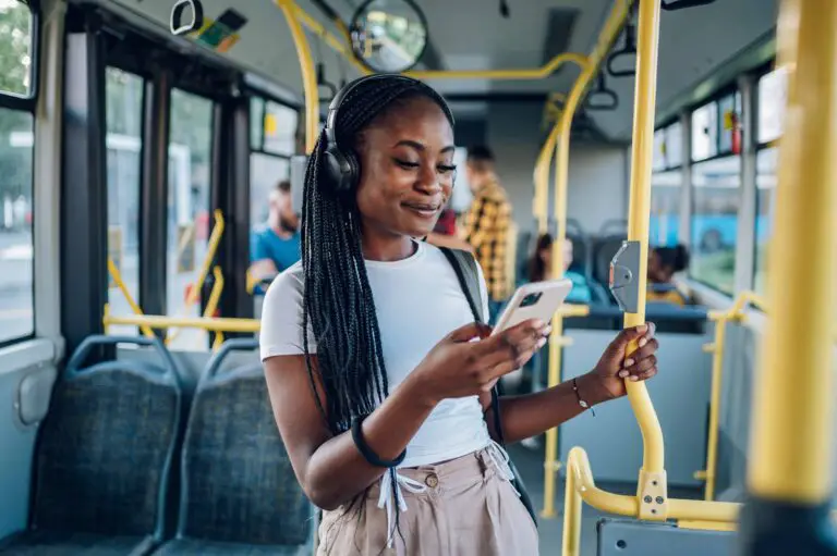 Woman looking at phone while traveling on a bus