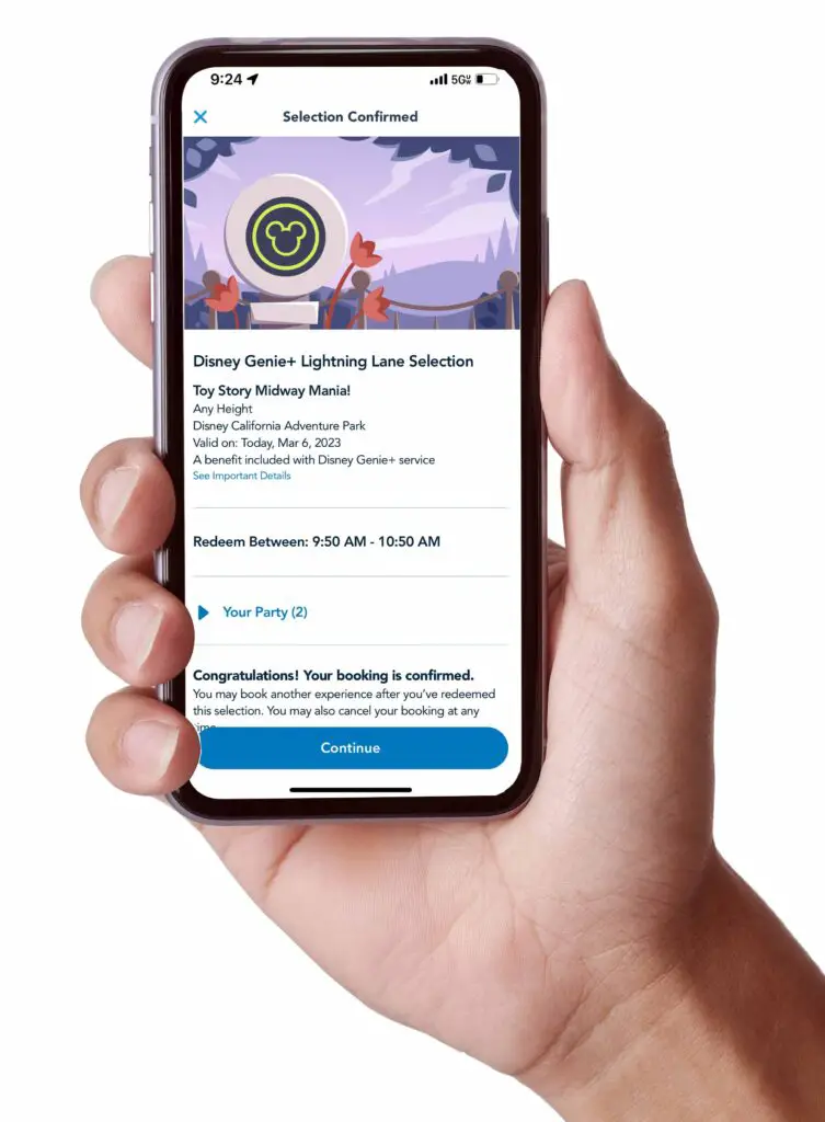 Hand holds phone showing a Disneyland Genie+ reservation for Toy Story Midway Mania