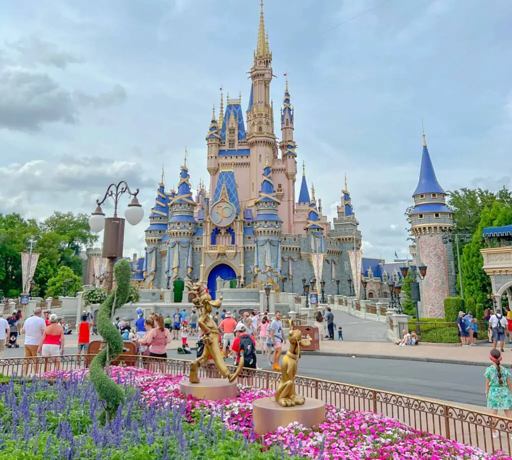 Disney World castle, with crowds in front - affording disney world vacation