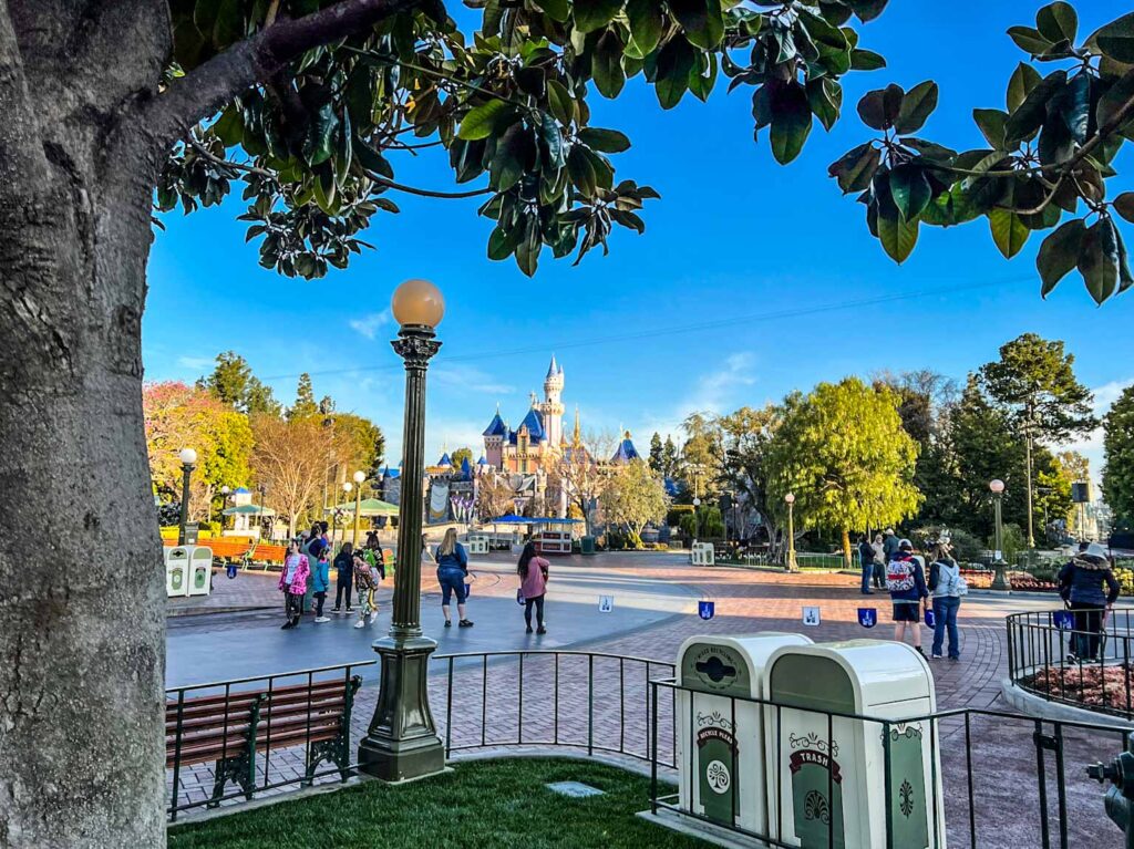 Sleeping Beauty Castle in the background, surrounded by empty pathways as guests wait for Disneyland early entry to open.