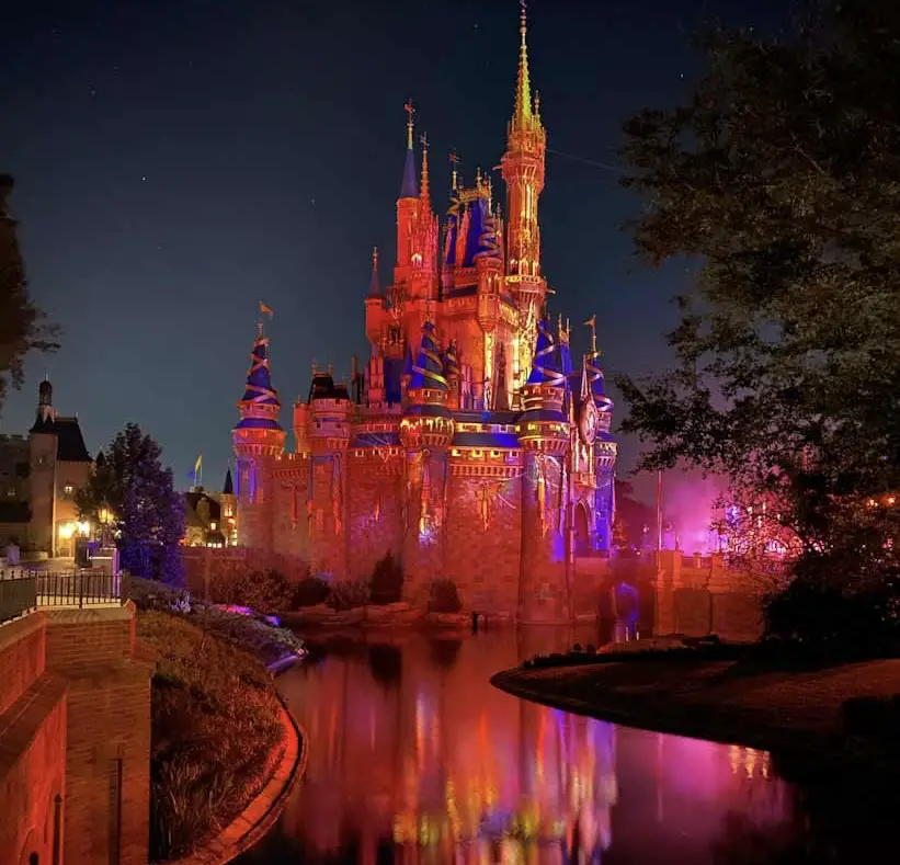 Cinderella's Castle bathed in orange light for MIckey's Not So Scary Halloween Party