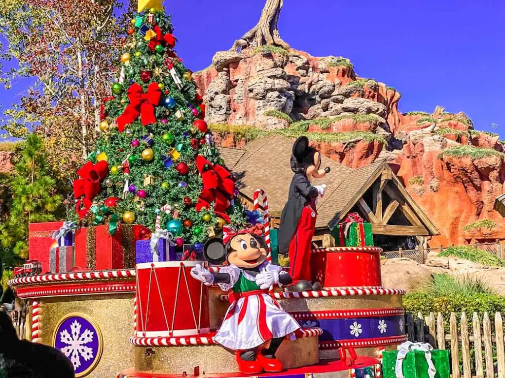 Minnie Mouse waves at Disney World first timers tduring a Christmas cavalcade