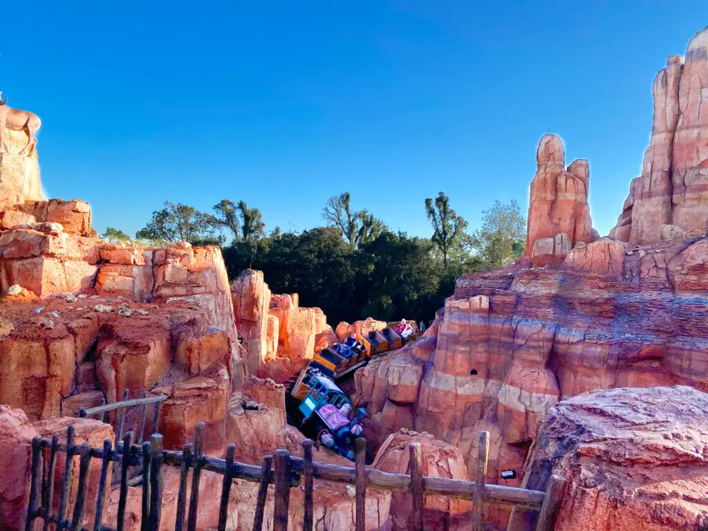 Train traveling through picturesque rocks on Big Thunder Mountain Railroad, one of the best experiences at Disney World