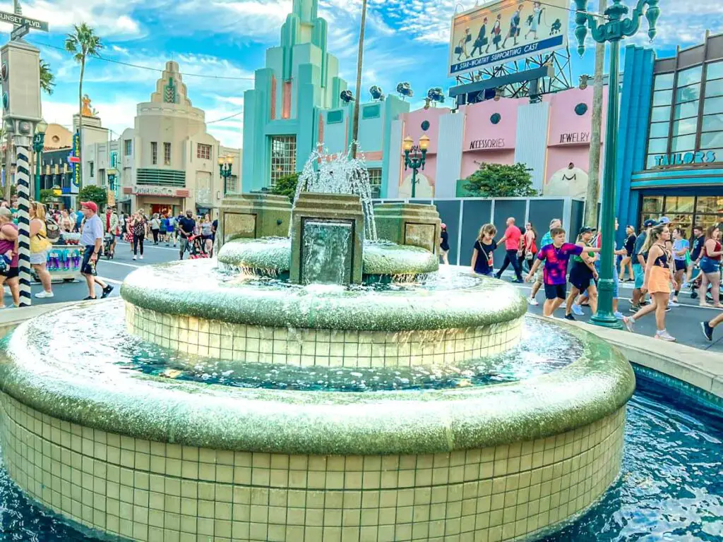 Fountain at Disney World Hollywood Studios, colorful buildings in the background.