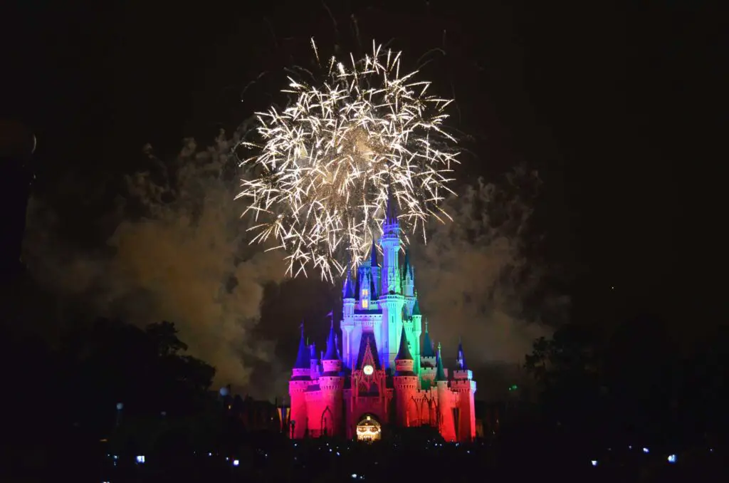 fireworks explode over Cinderella's Castle at Magic Kingdom at night.