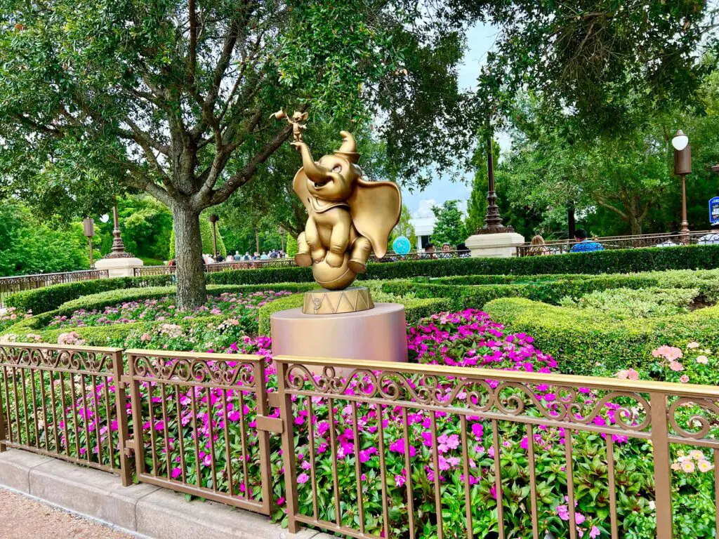Dumbo statue in a bed of flowers at Disney World in spring