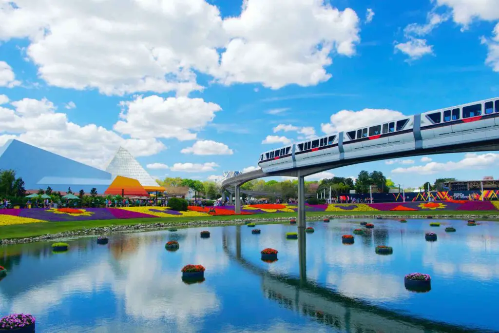 Monorail glides over flowers in water at EPCOT Flower Garden Festival