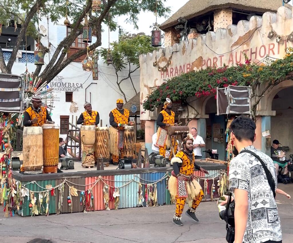 street performers lead guests in a dance at disney Animal Kingdom