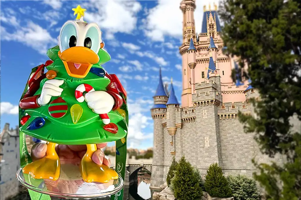 Donald Duck Christmas Tree sipper held up beside Cinderella's Castle