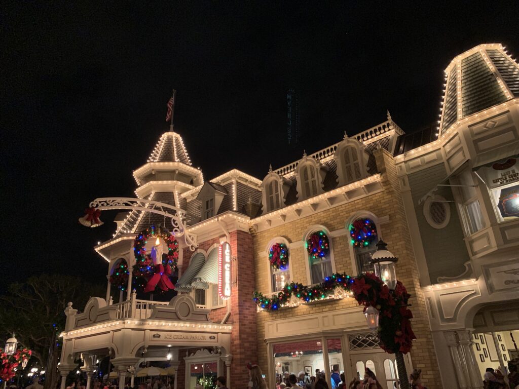 At Disney World, Christmas time is celebrated with wreaths and garlands along the buildings of Main ST USA 