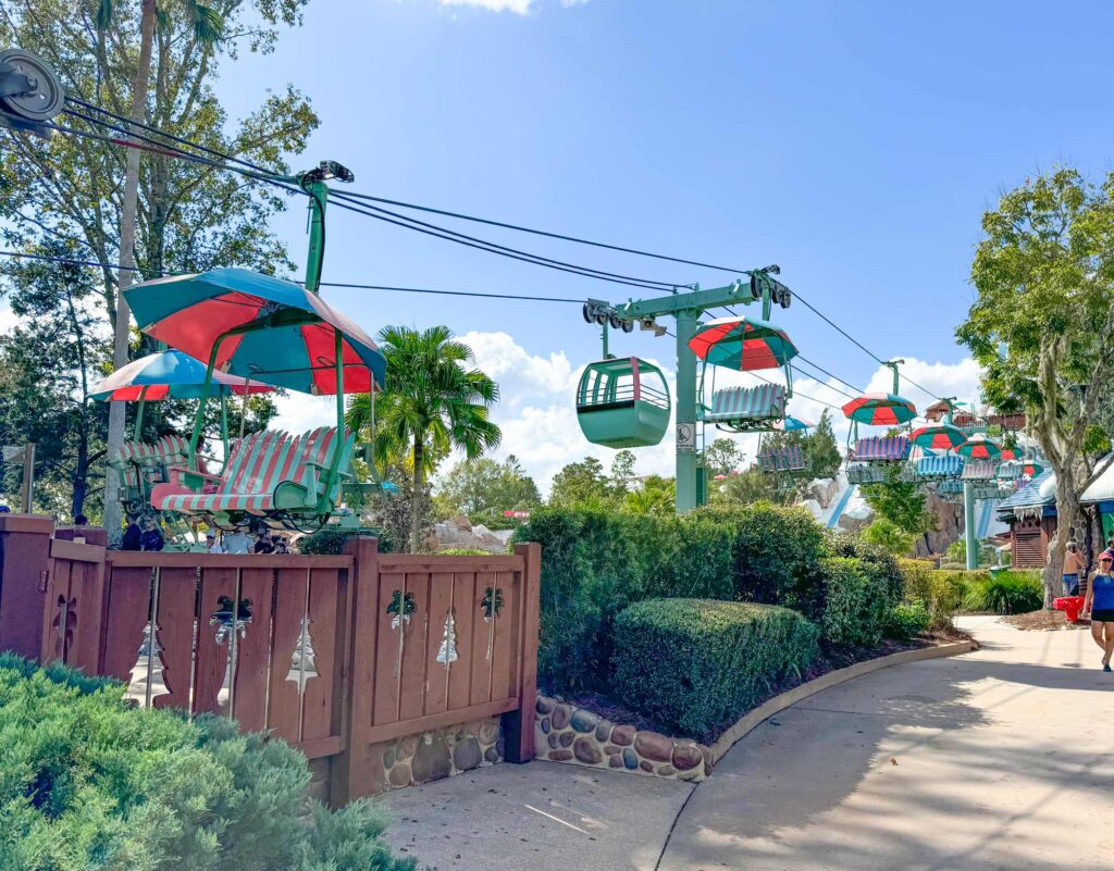 colorful chairlift glides over Blizzard Beach water park walkway