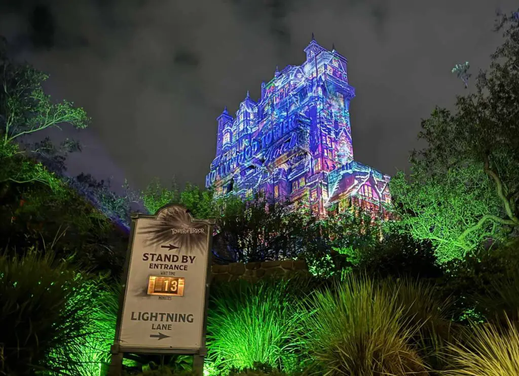 The Hollywood Tower Hotel dressed in holiday overlay of blue and purple hues at disney world Jollywood nights.