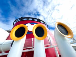 White ship horns before a red smoke stack on a Disney cruise line ship