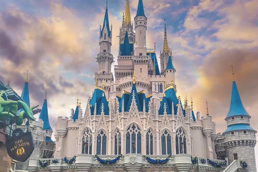 Magic Kingdom castle with colored sky.