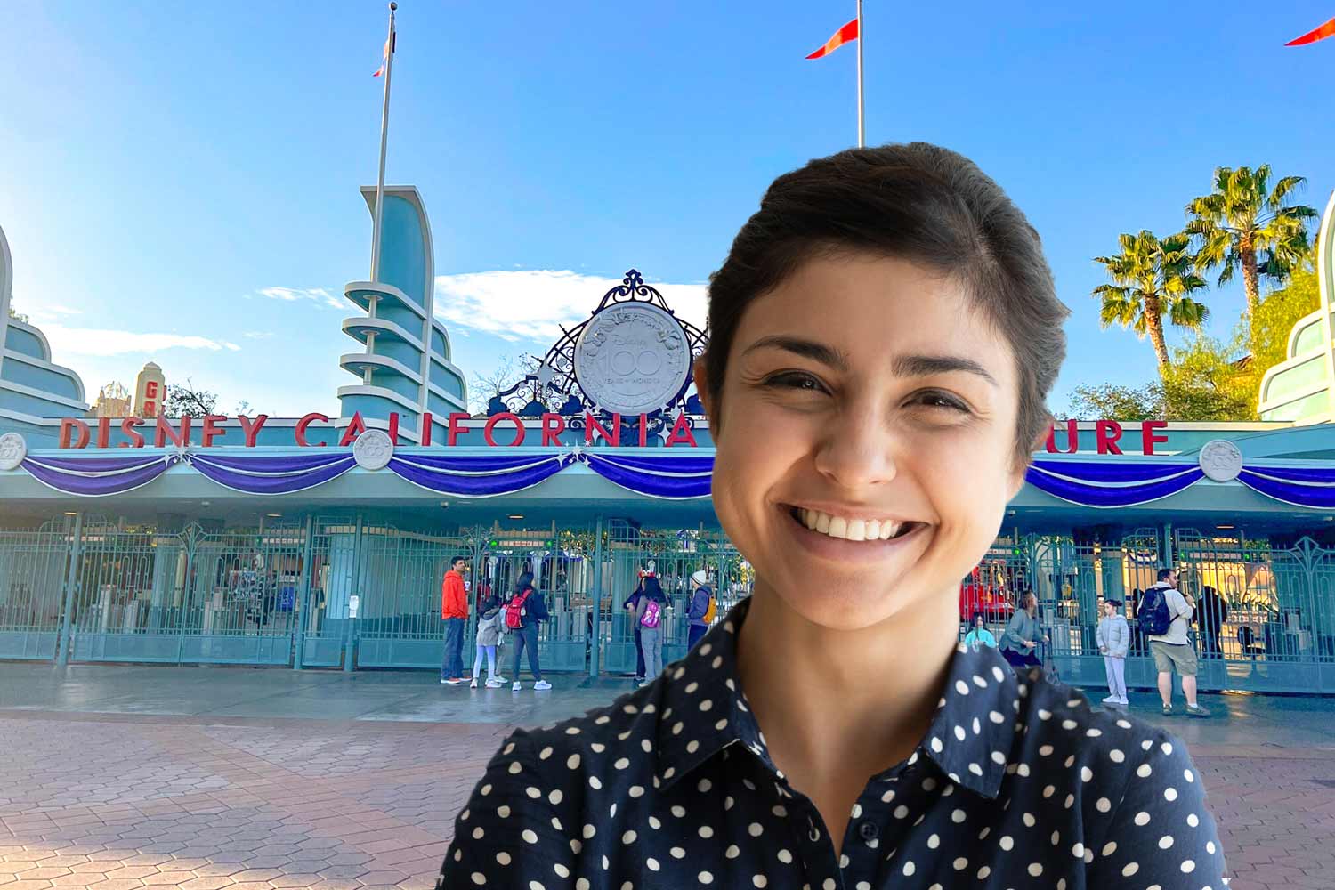 woman gets her picture taken at Disneyland in front of California Adventure gates